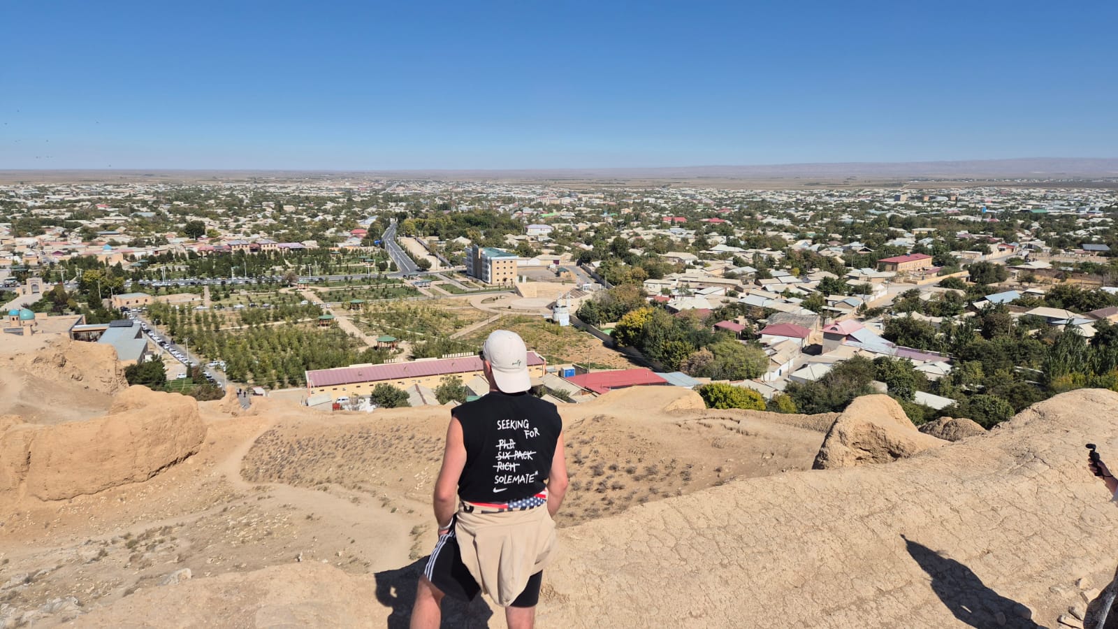 One person looking out over a city from an old fortress wall — from the founders' own travel photos